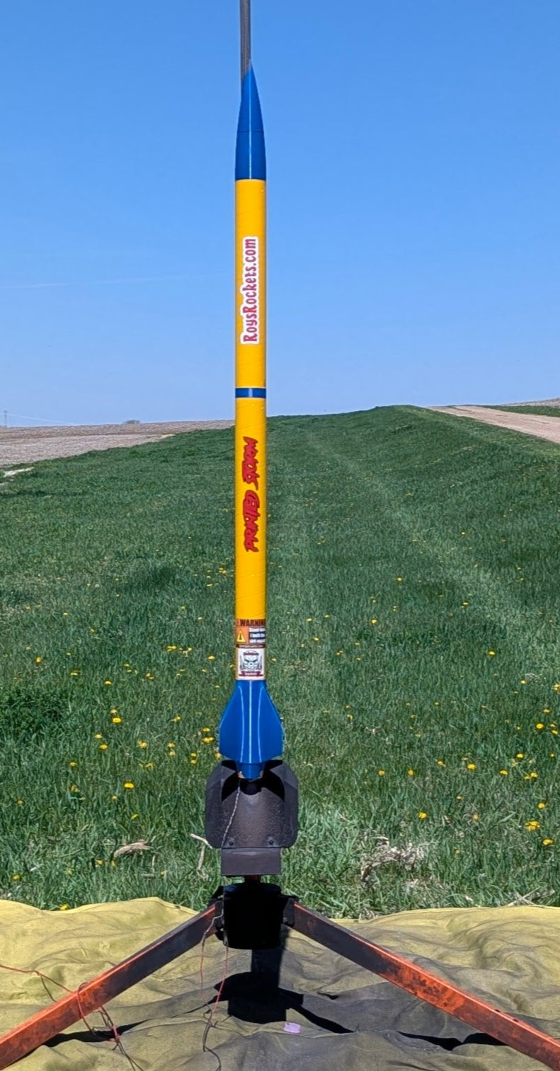 Model rocket on a stand with a clear blue sky background